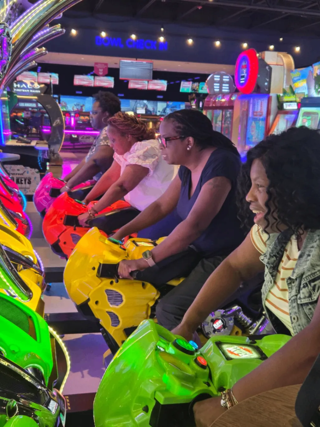 Team members laughing together at an arcade